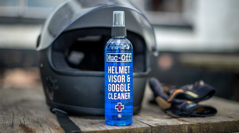 Muc-Off Helmet Visor and Goggle Cleaner 250ml beside a helmet