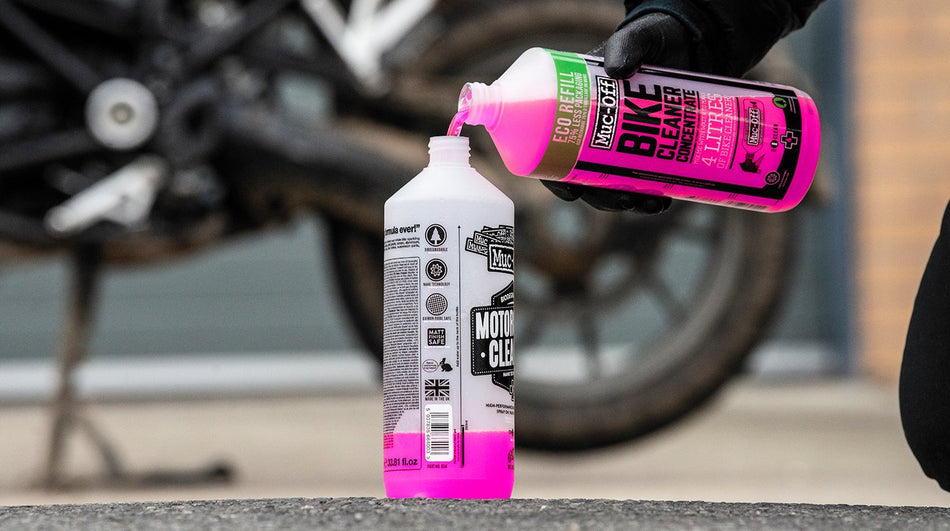Muc-Off Bike Cleaner Concentrate 1L poured into a reusable cleaner bottle