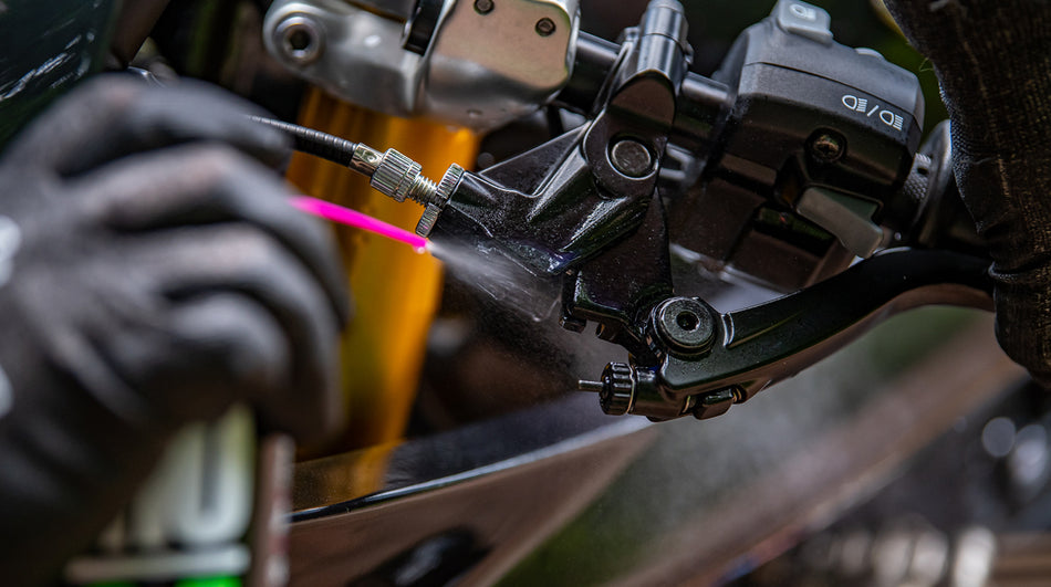 Detail of spray application to a motorcycle control pivot