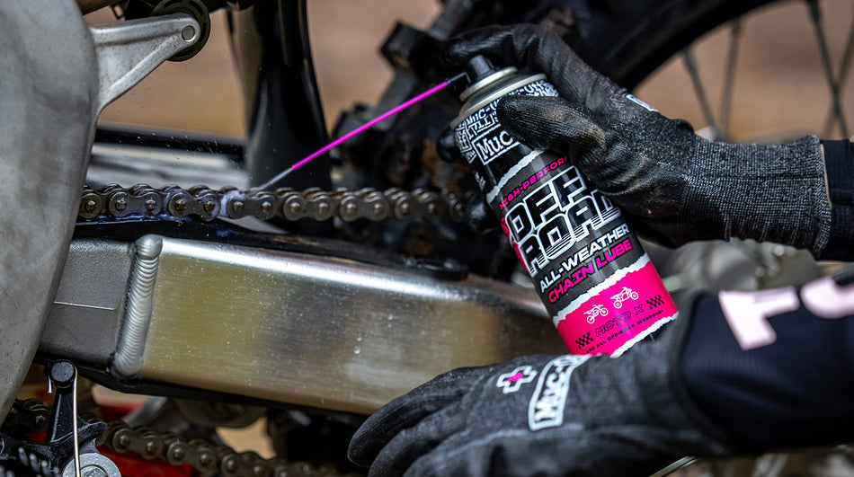 Muc-Off Off-Road All-Weather Chain Lube applied to a motorcycle chain