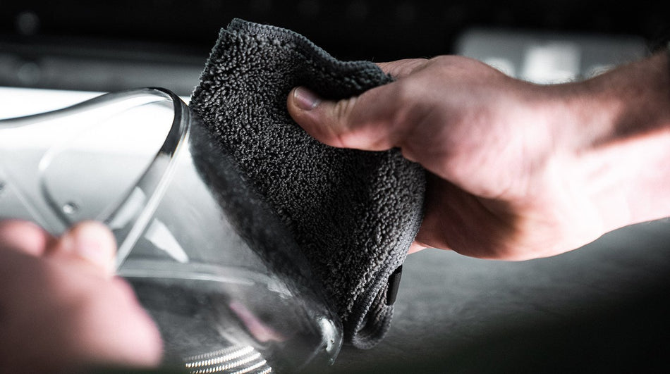 Polishing a helmet visor with the Helmet Visor and Goggle Cleaning Kit cloth