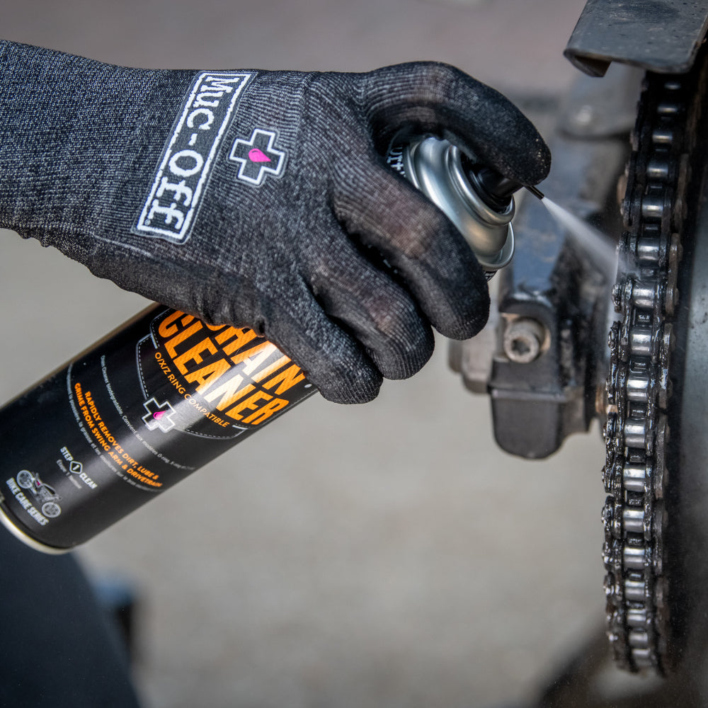 Muc-Off Motorcycle Chain Cleaner being applied to a motorcycle chain