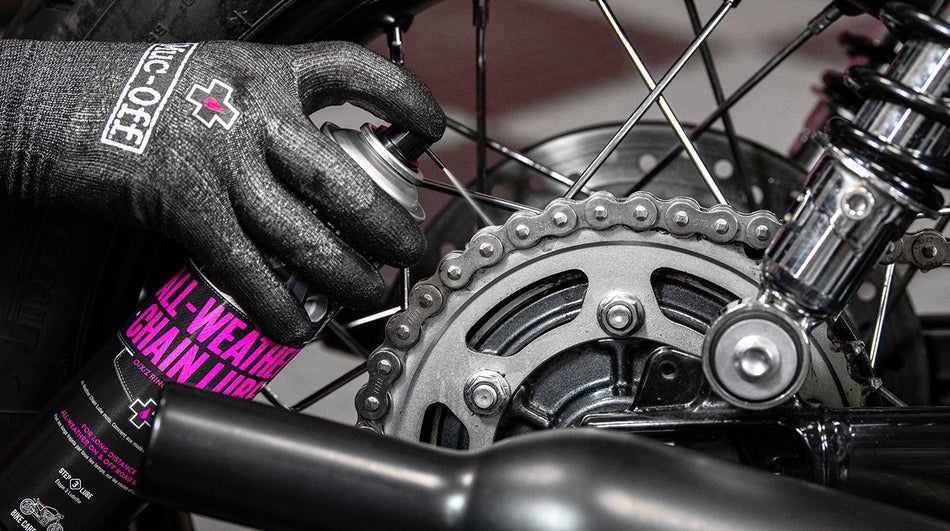 Muc-Off All-Weather Chain Lube applied to a motorcycle chain and sprocket