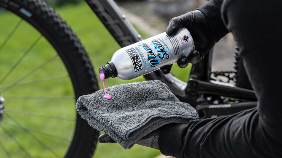 Muc-Off Miracle Shine 500ml dispensed onto a microfibre cloth