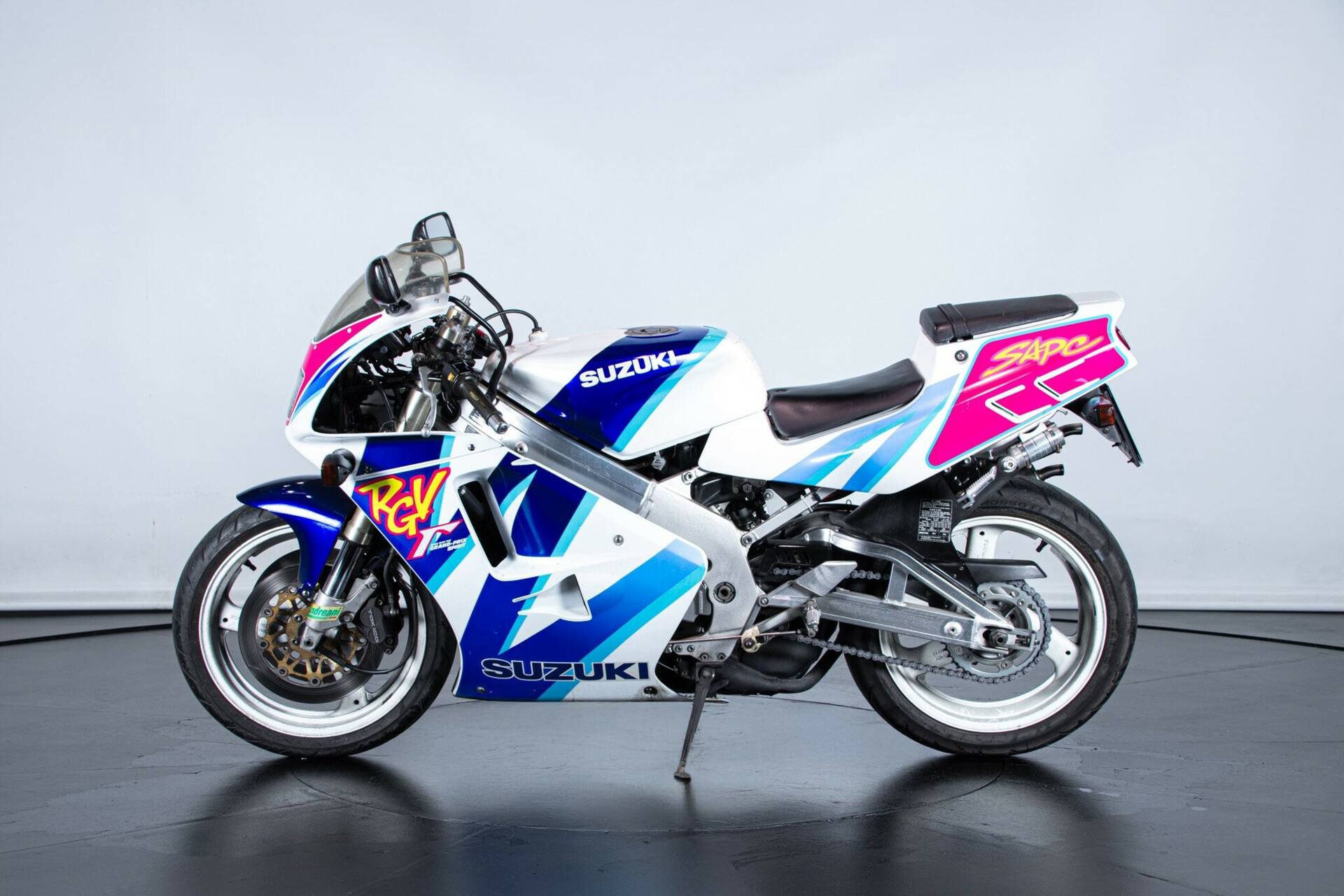 Suzuki RGV motorcycle in white, blue, turquoise and pink graphics