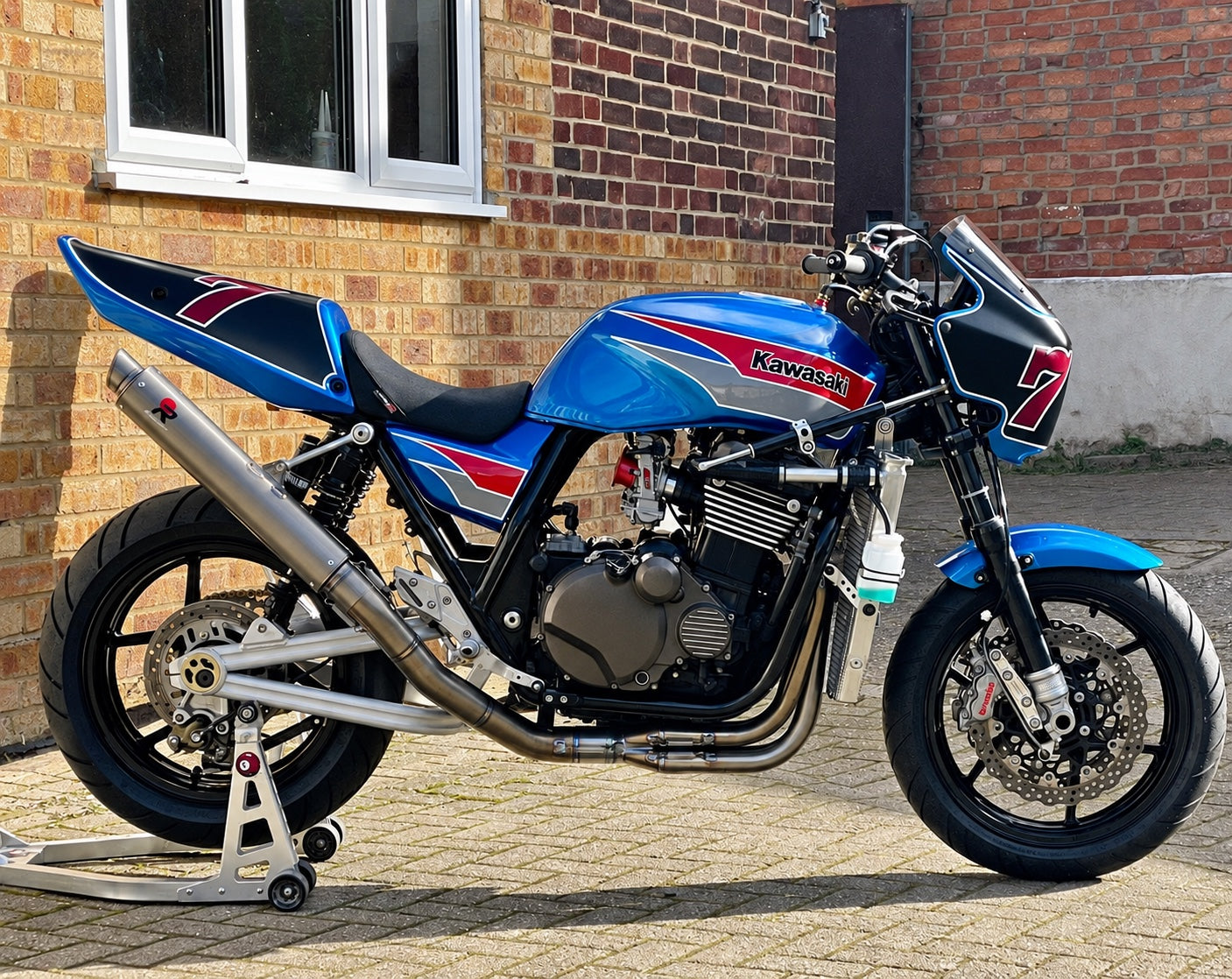 Blue Kawasaki ZRX 1100 with a complete red, silver and black custom paint scheme